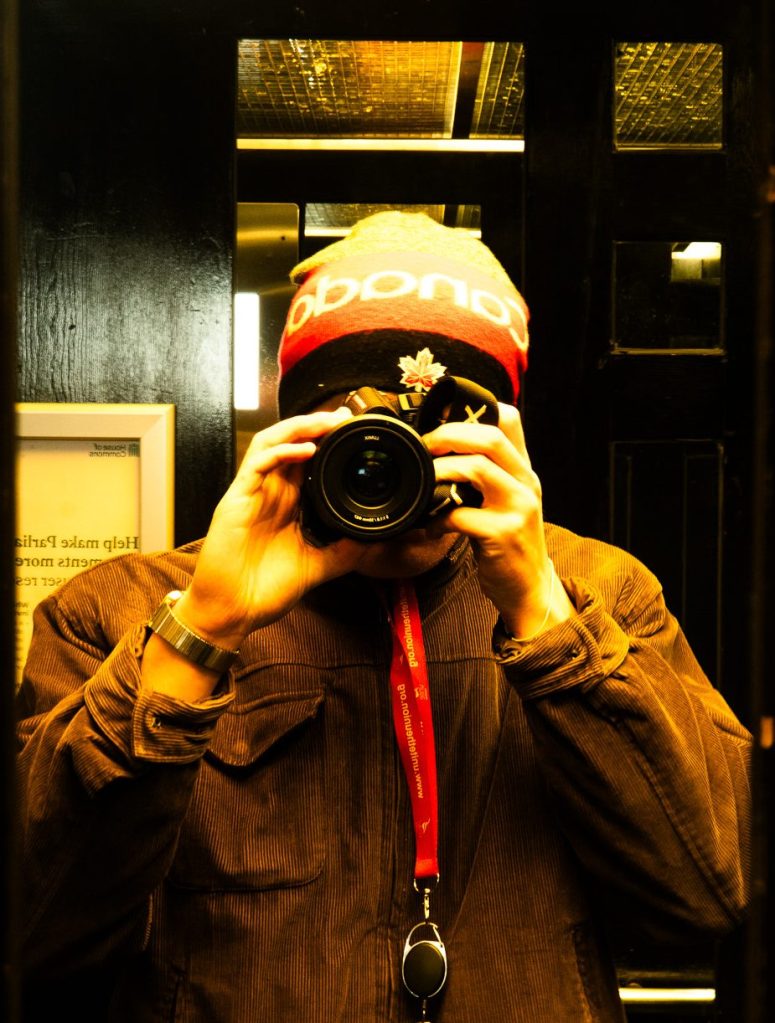 Man taking a self-portrait in a lift